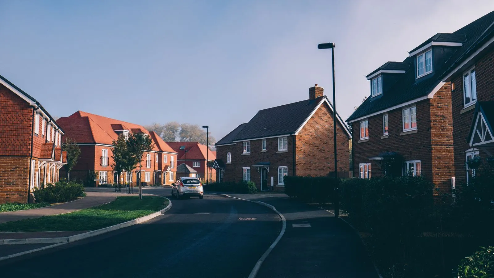 Brick homes on a Cambridge-area street — heat pump prices here are shaped by wall type, radiator sizes and the city's frosty winters.